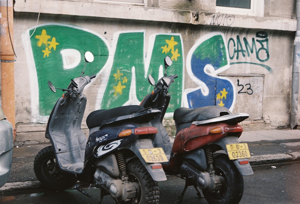 a couple of scooters parked next to a building