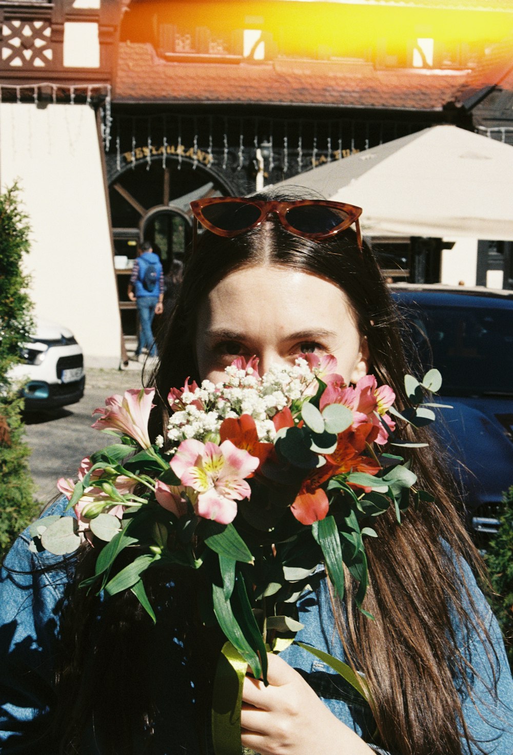 a woman holding a bunch of flowers in her hands