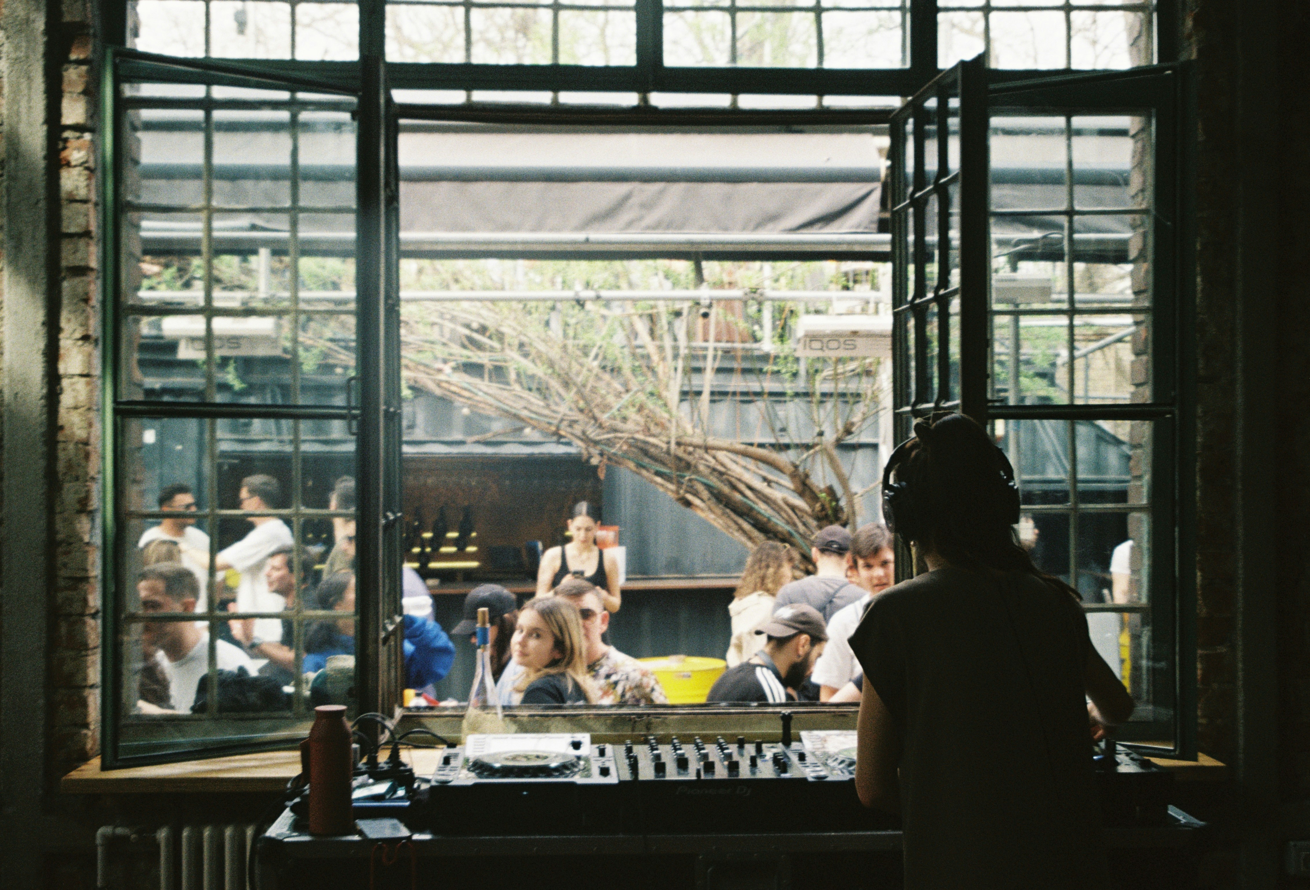 a group of people sitting around a table in front of a window