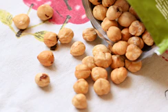 a bowl filled with nuts sitting on top of a table