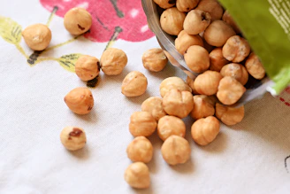 a bowl filled with nuts sitting on top of a table