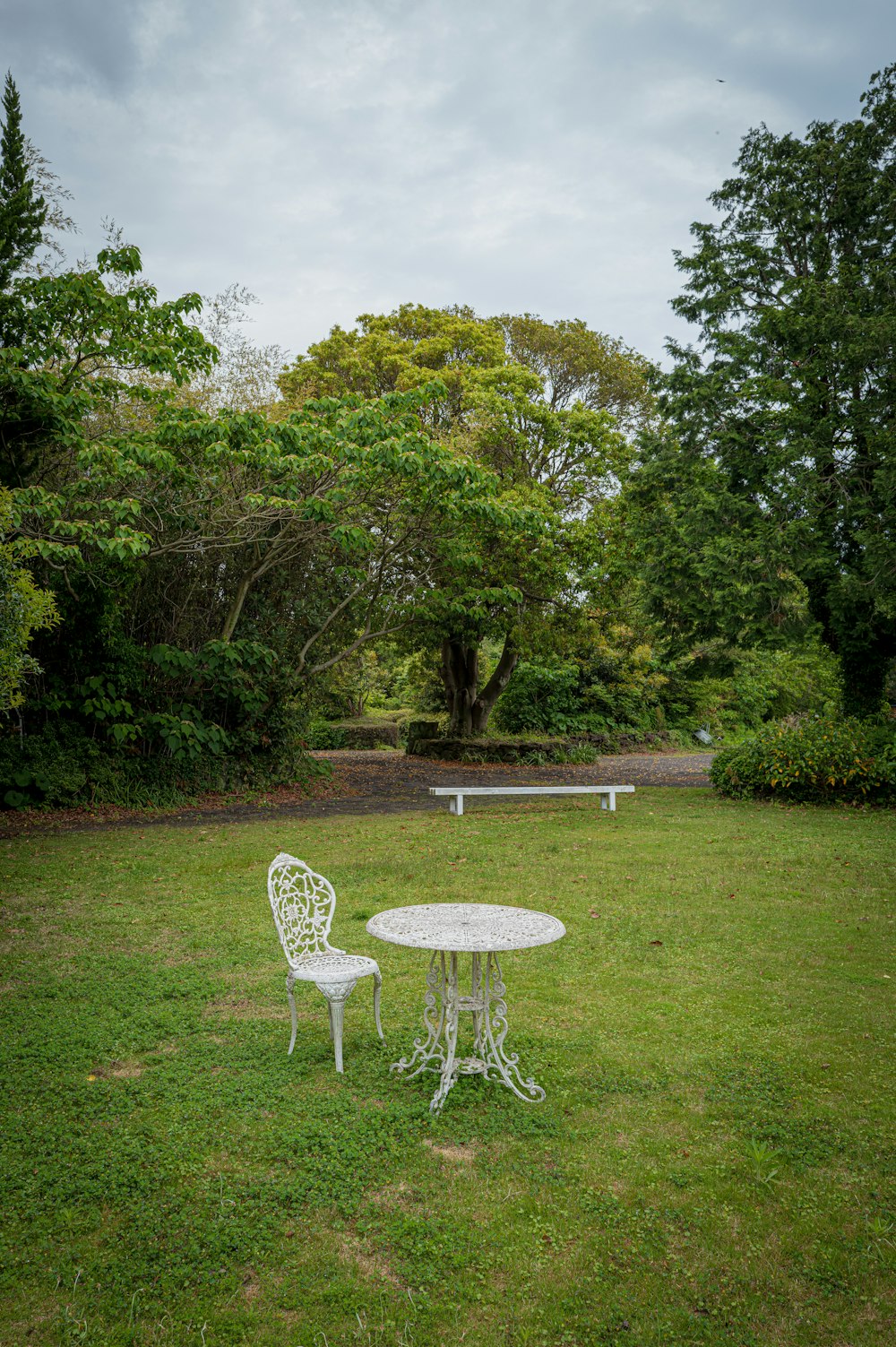 a white table and chairs in a grassy area