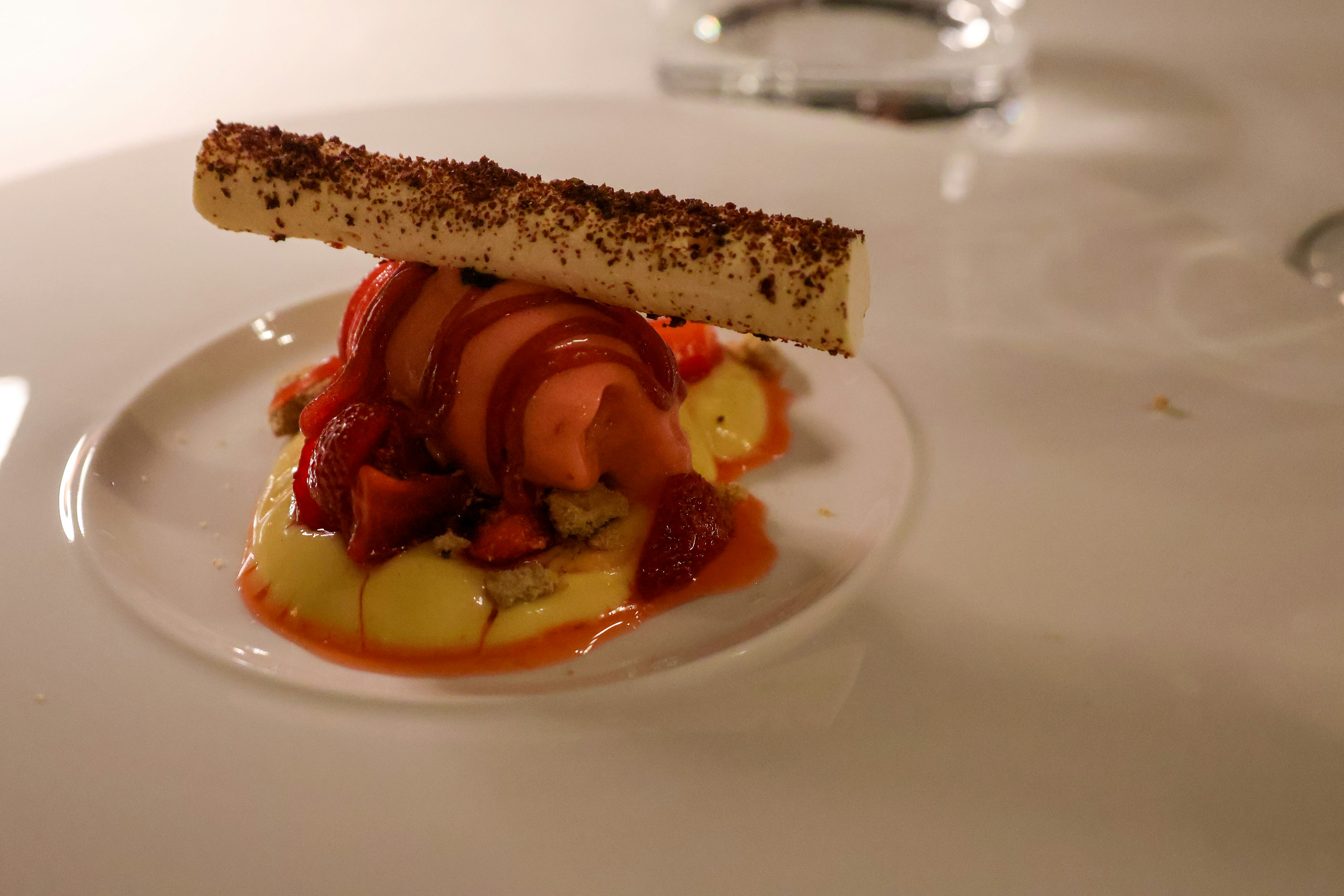 A plate of traditional Swedish meatballs served with mashed potatoes, lingonberry sauce, and pickled cucumber