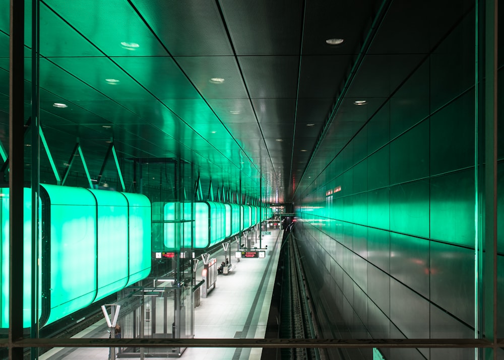 a long tunnel with green lights in the middle of it