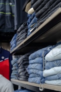 a store shelf filled with lots of blue jeans