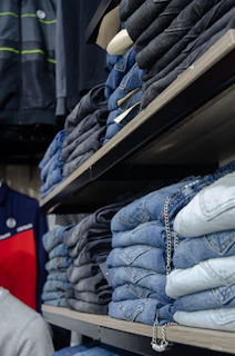 a store shelf filled with lots of blue jeans