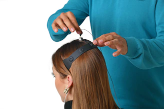 a woman getting her hair cut by a hair stylist