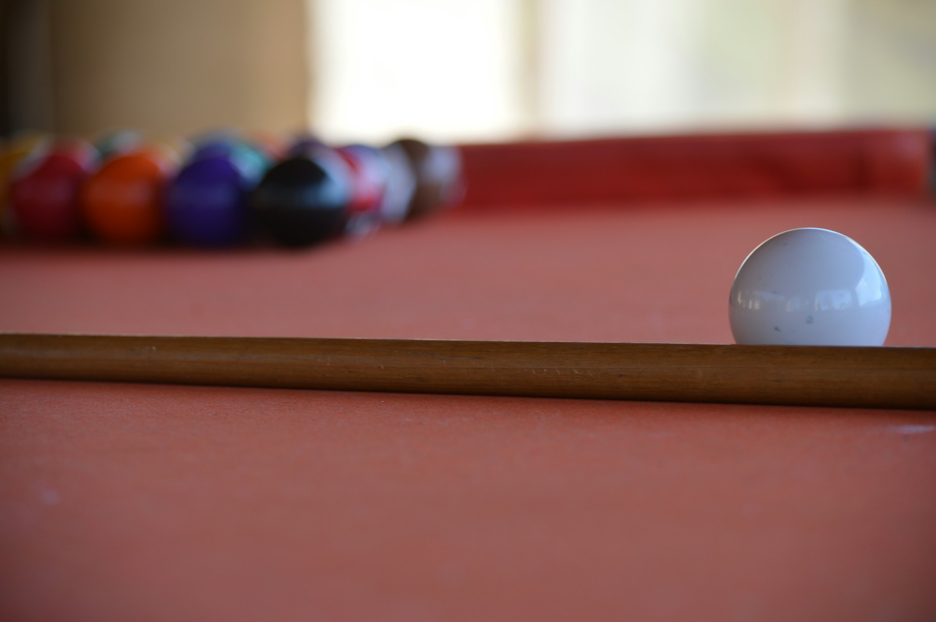 a pool table with a pool ball and cues