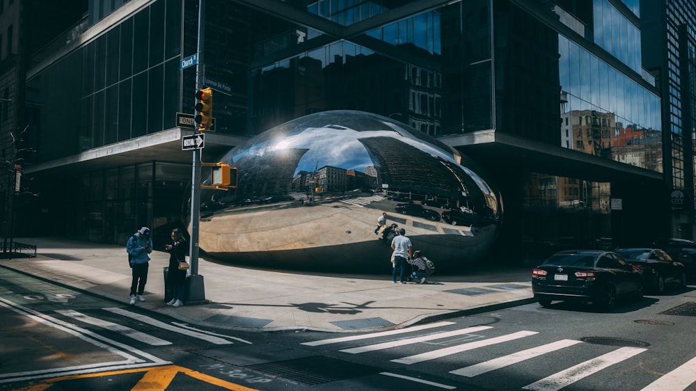 a large shiny ball sitting on the side of a road