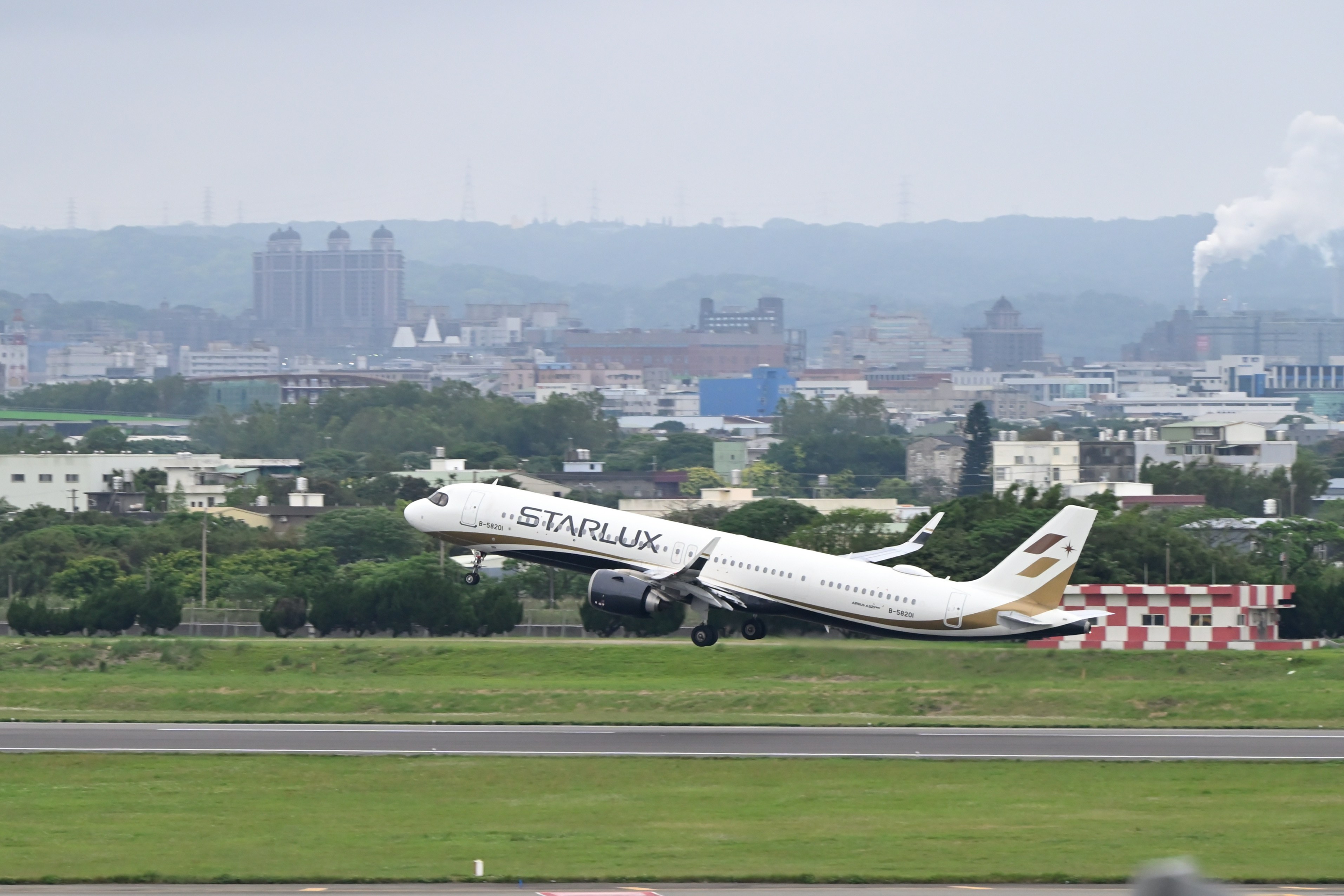 a large jetliner taking off from an airport runway, 
