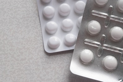 a pack of pills next to a contraption on a table