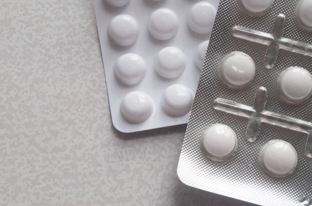 a pack of pills next to a contraption on a table