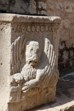 a stone statue of an angel holding a book
