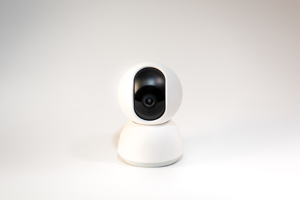 a white camera sitting on top of a white table