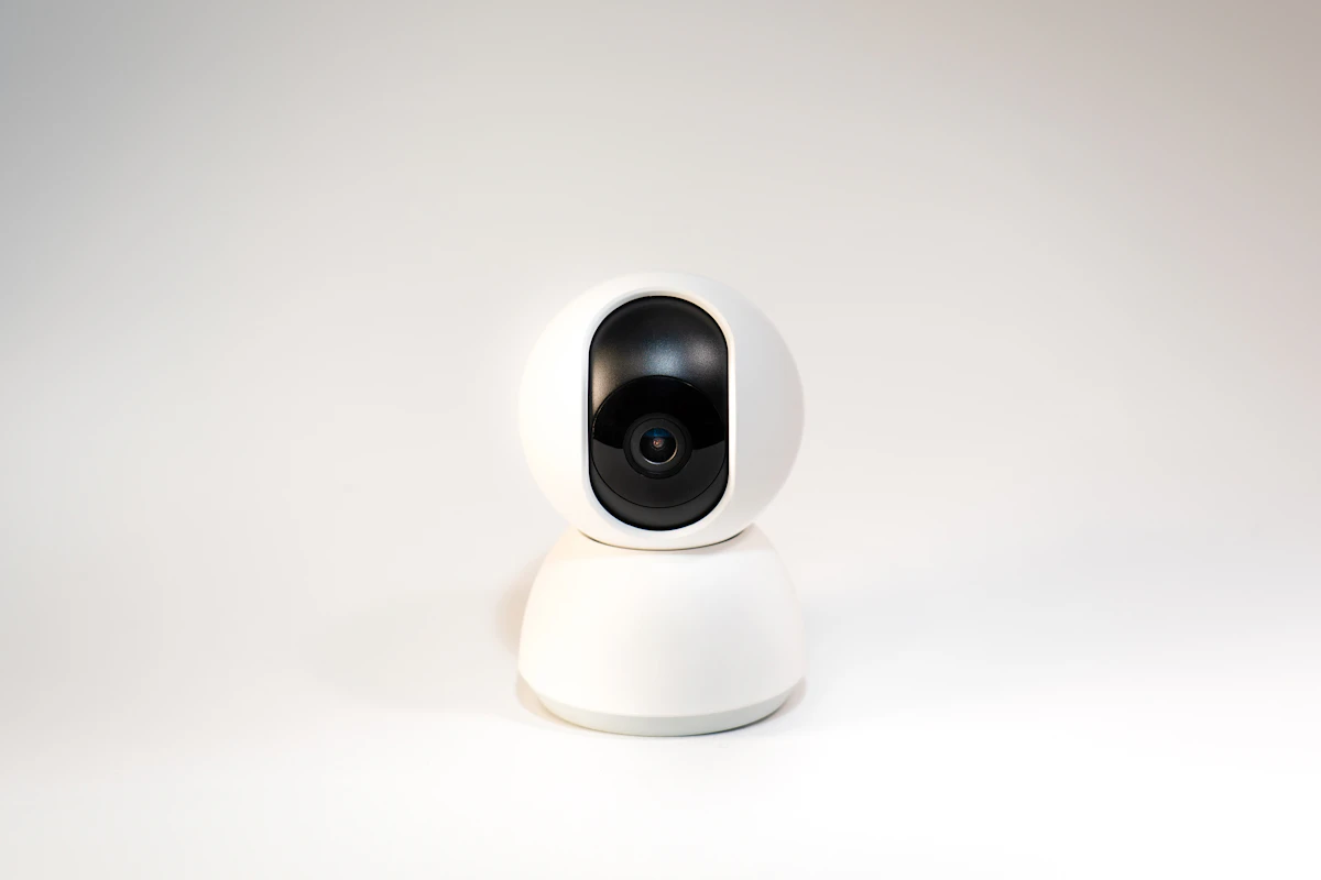 A white camera sitting on top of a white table