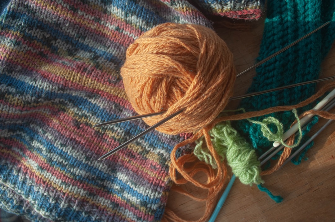 Knitting and crochet equipment: yarn ball and threads, hooks, needles. Hobby tools.