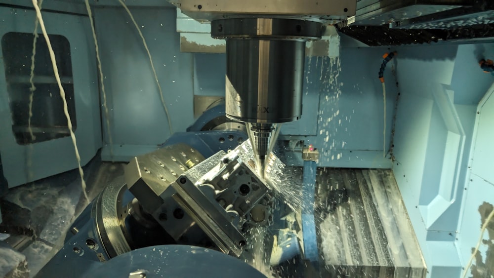 a machine that is cutting a piece of metal