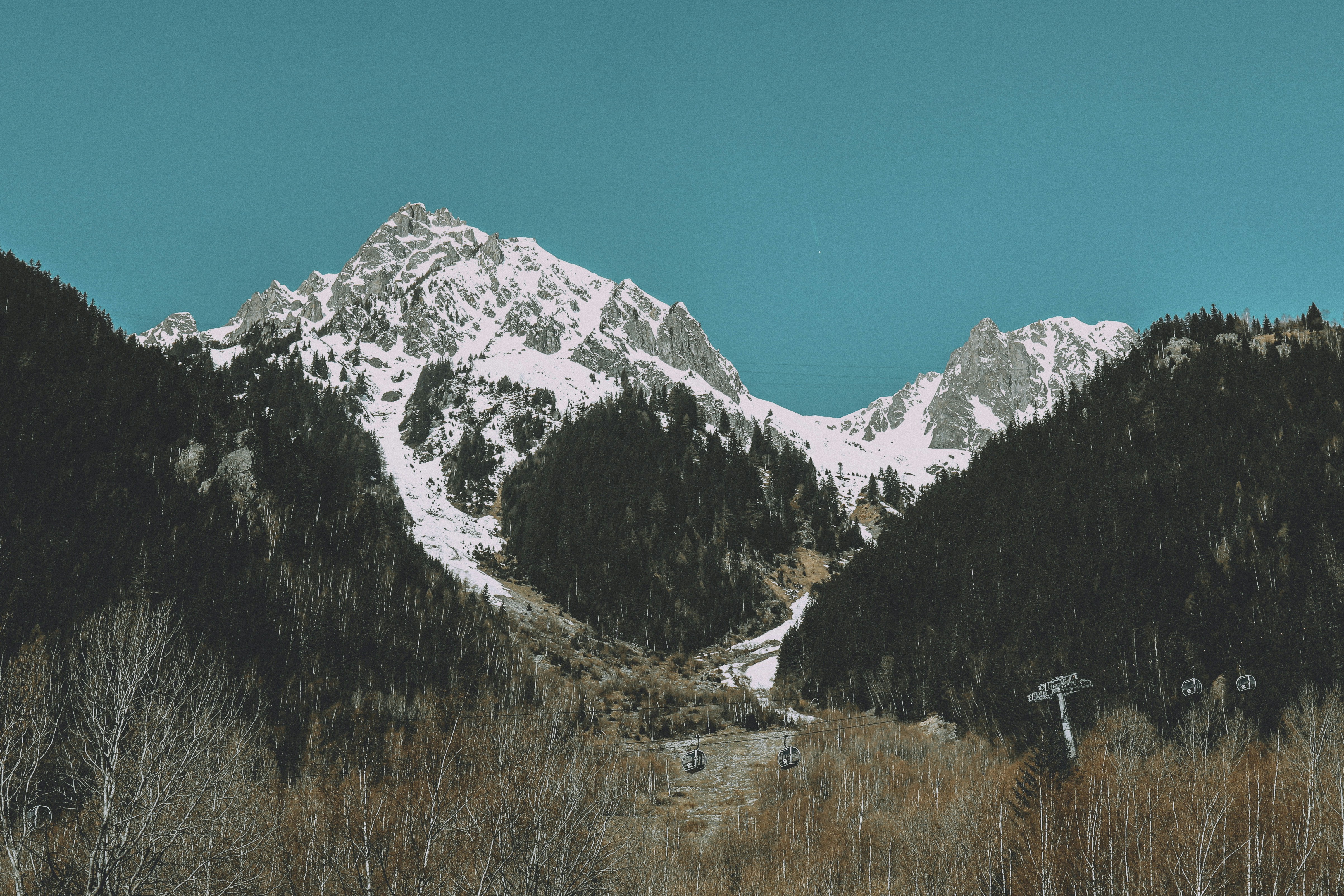 a snow covered mountain with a trail going through it
