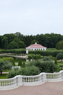 a white house surrounded by trees and bushes