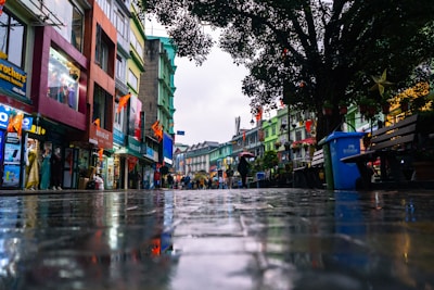 a wet street with people walking down it