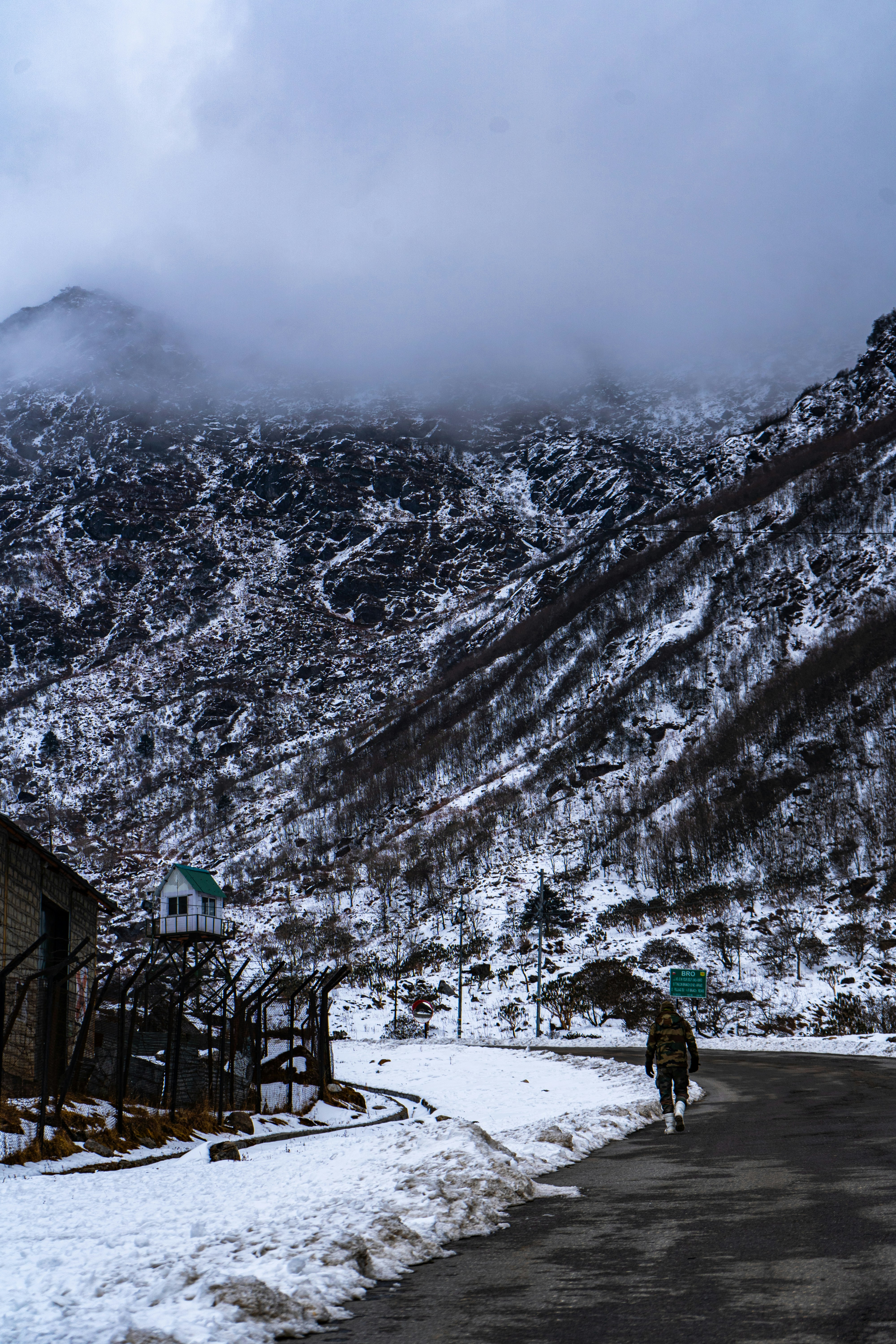 a man riding a bike down a snow covered road