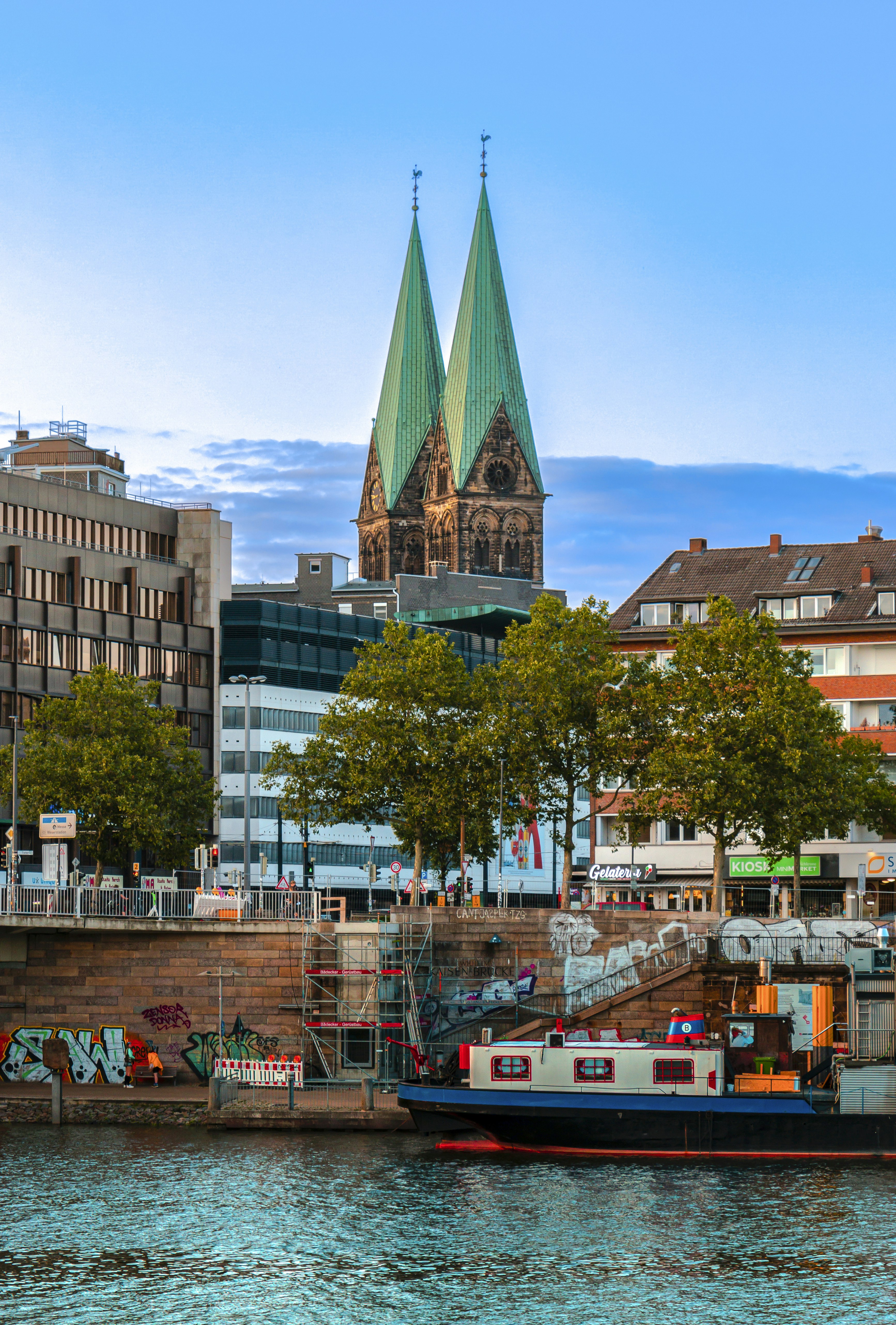 a boat in the water in front of a city