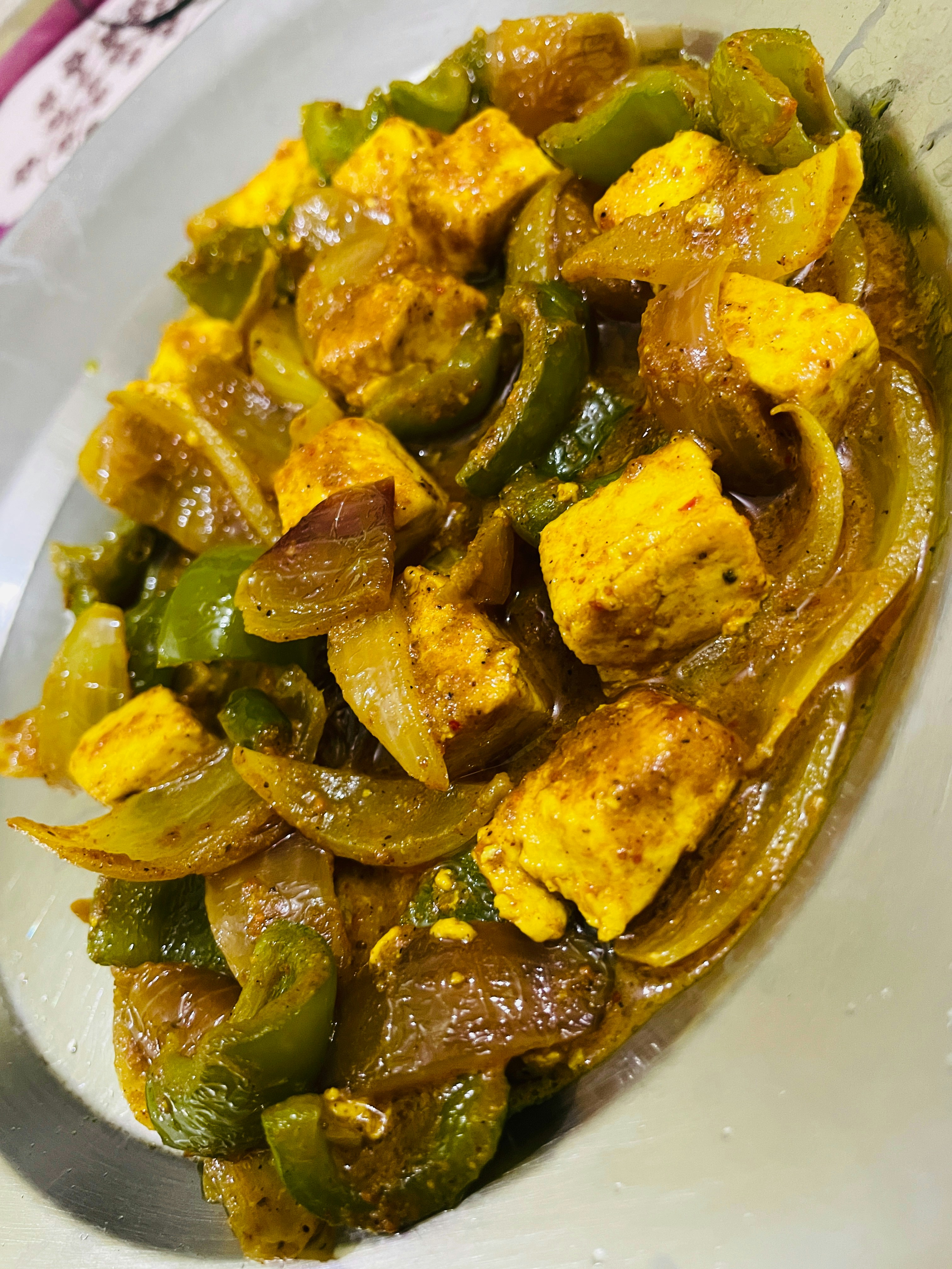 Golden crispy paneer cubes with colorful bell peppers in chilli sauce