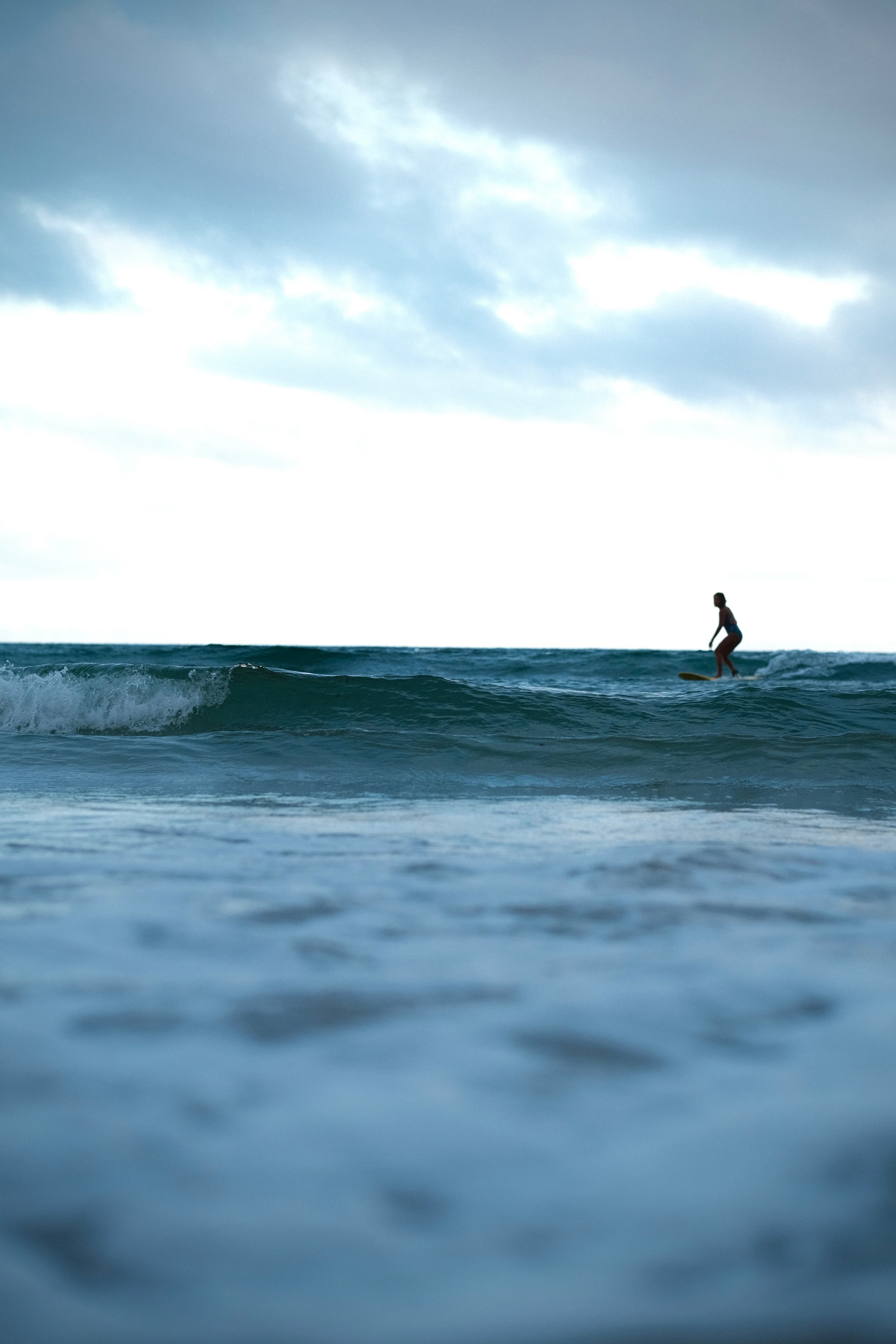Surfer walking along the Cloud 9 boardwalk at sunrise