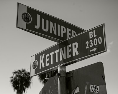 a black and white photo of a street sign