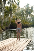 a man standing on top of a bamboo raft