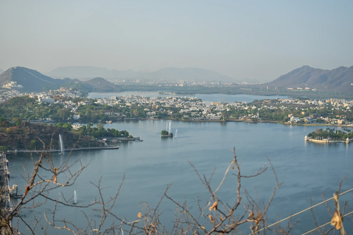 A lake surrounded by hills and the city