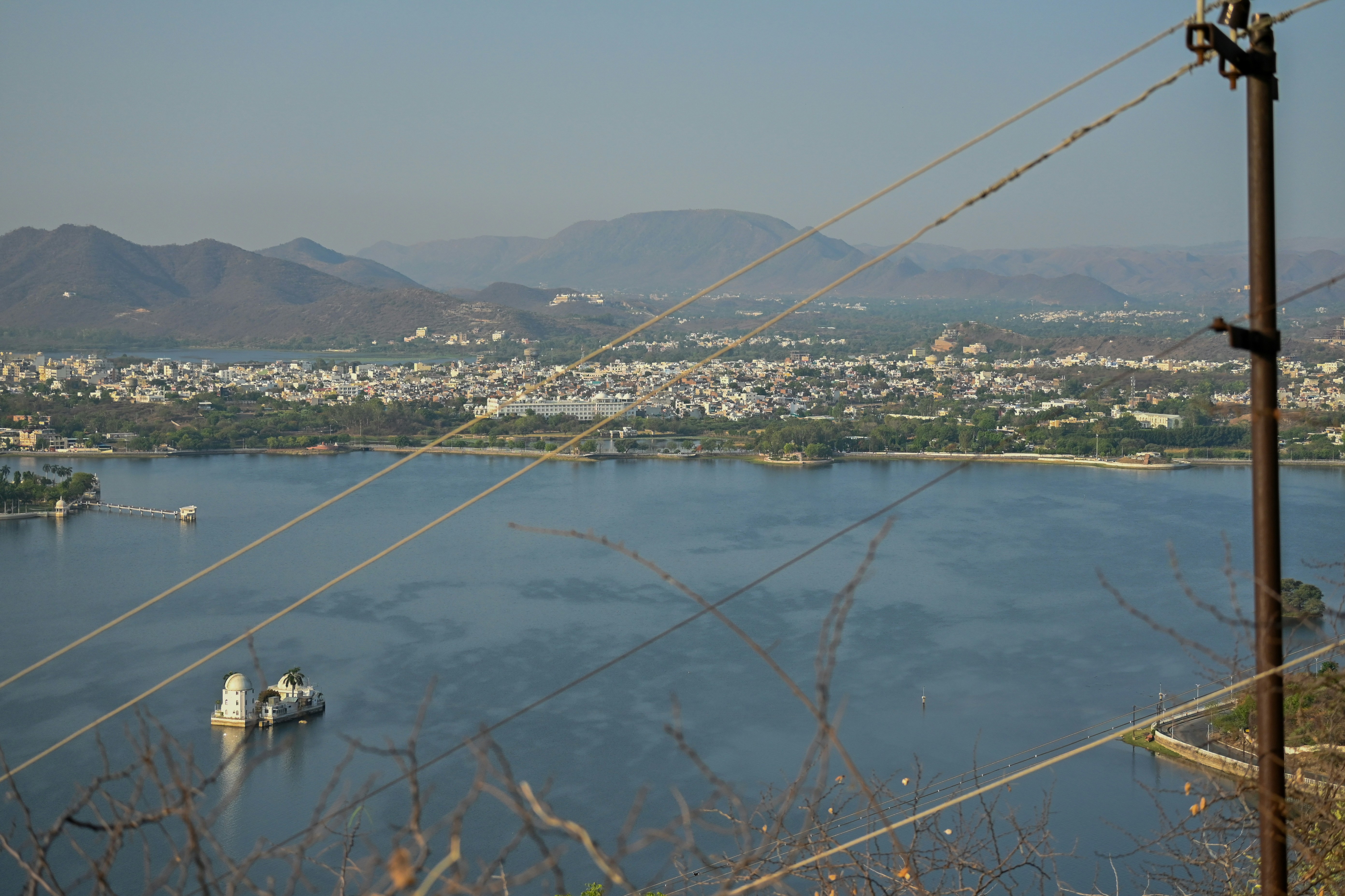Body of water surrounded by mountains and city