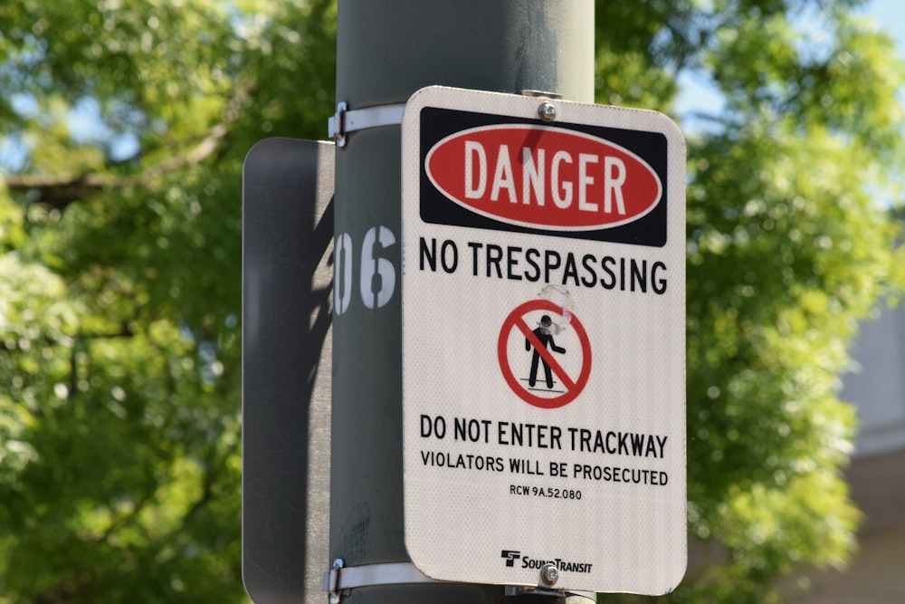 a sign on a street pole warning of no trespassing