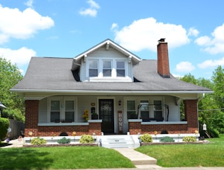 a white house with a black roof and white trim