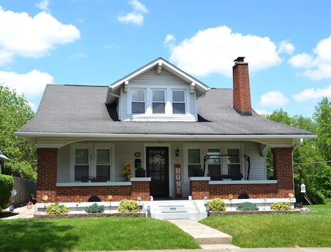 a white house with a black roof and white trim