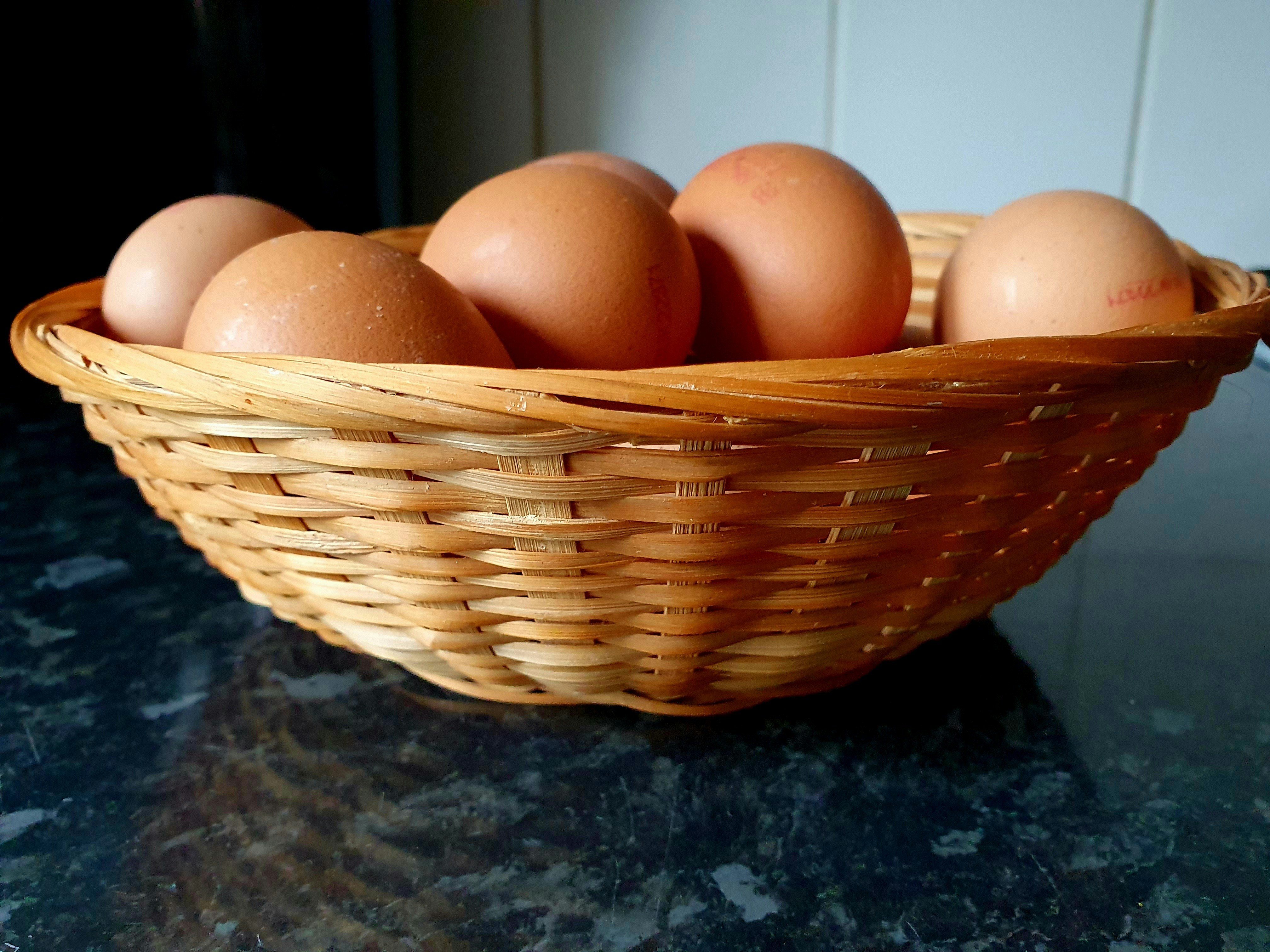 a basket of eggs sitting on a counter top