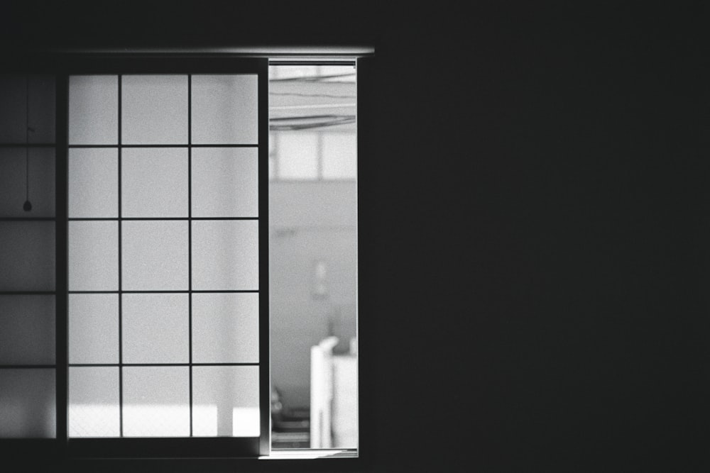 a black and white photo of an open window