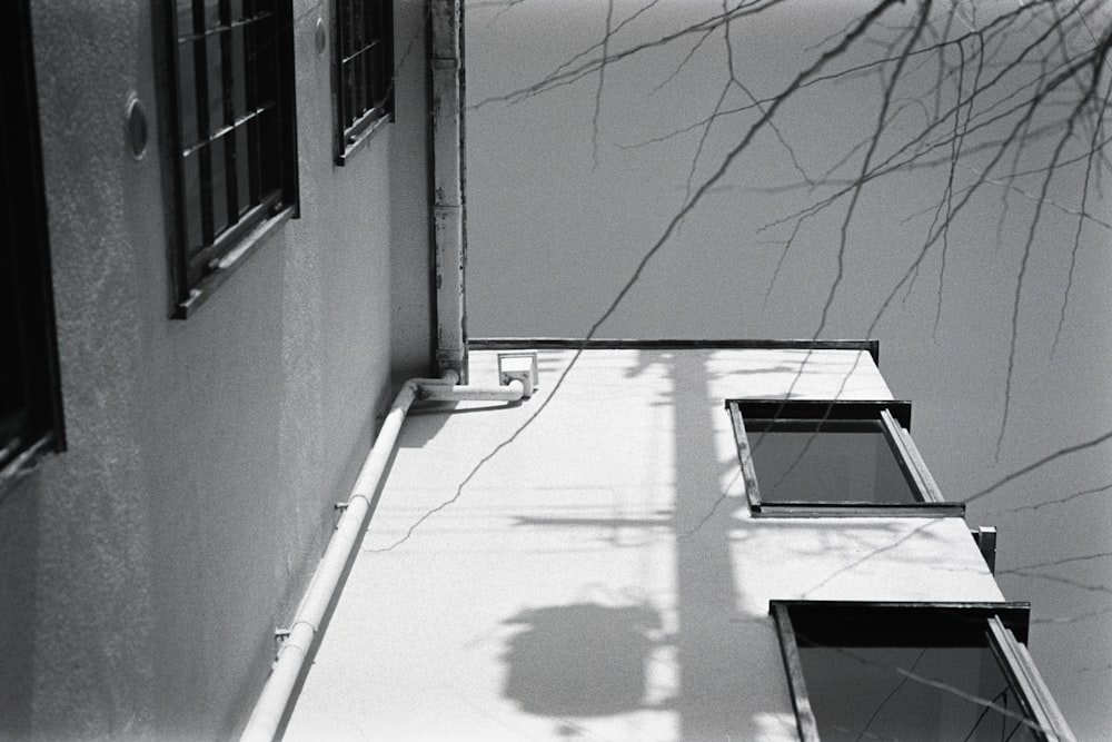 a black and white photo of a shadow of a building