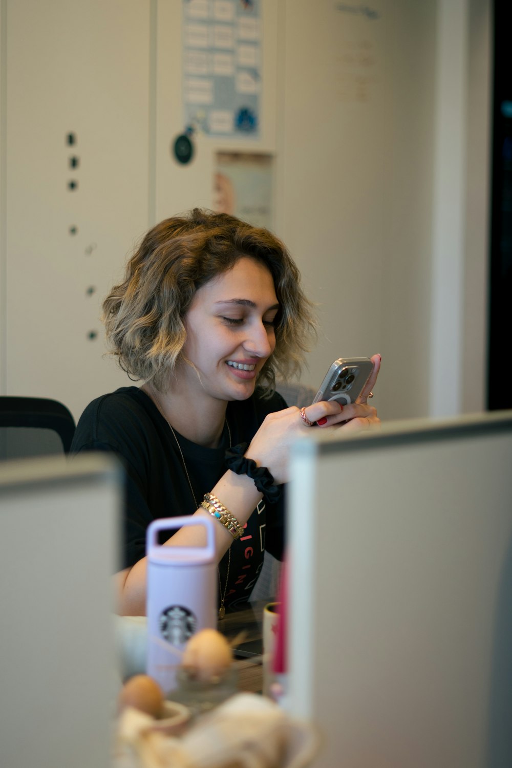 a woman sitting in front of a laptop computer