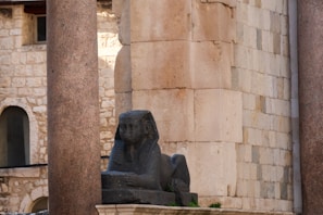 a stone statue of an elephant in front of a building