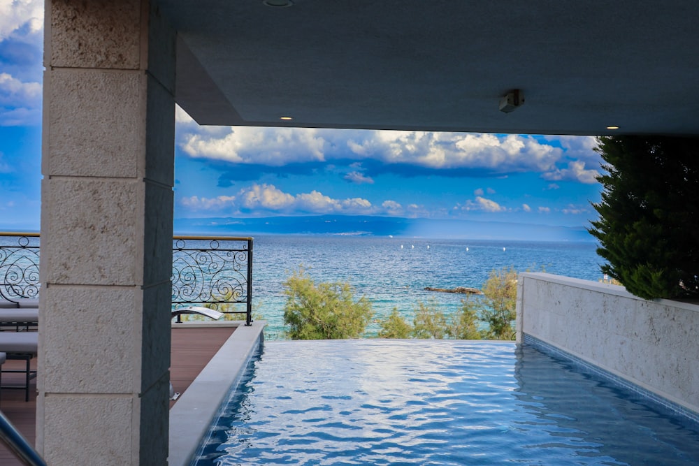 a large swimming pool with a view of the ocean