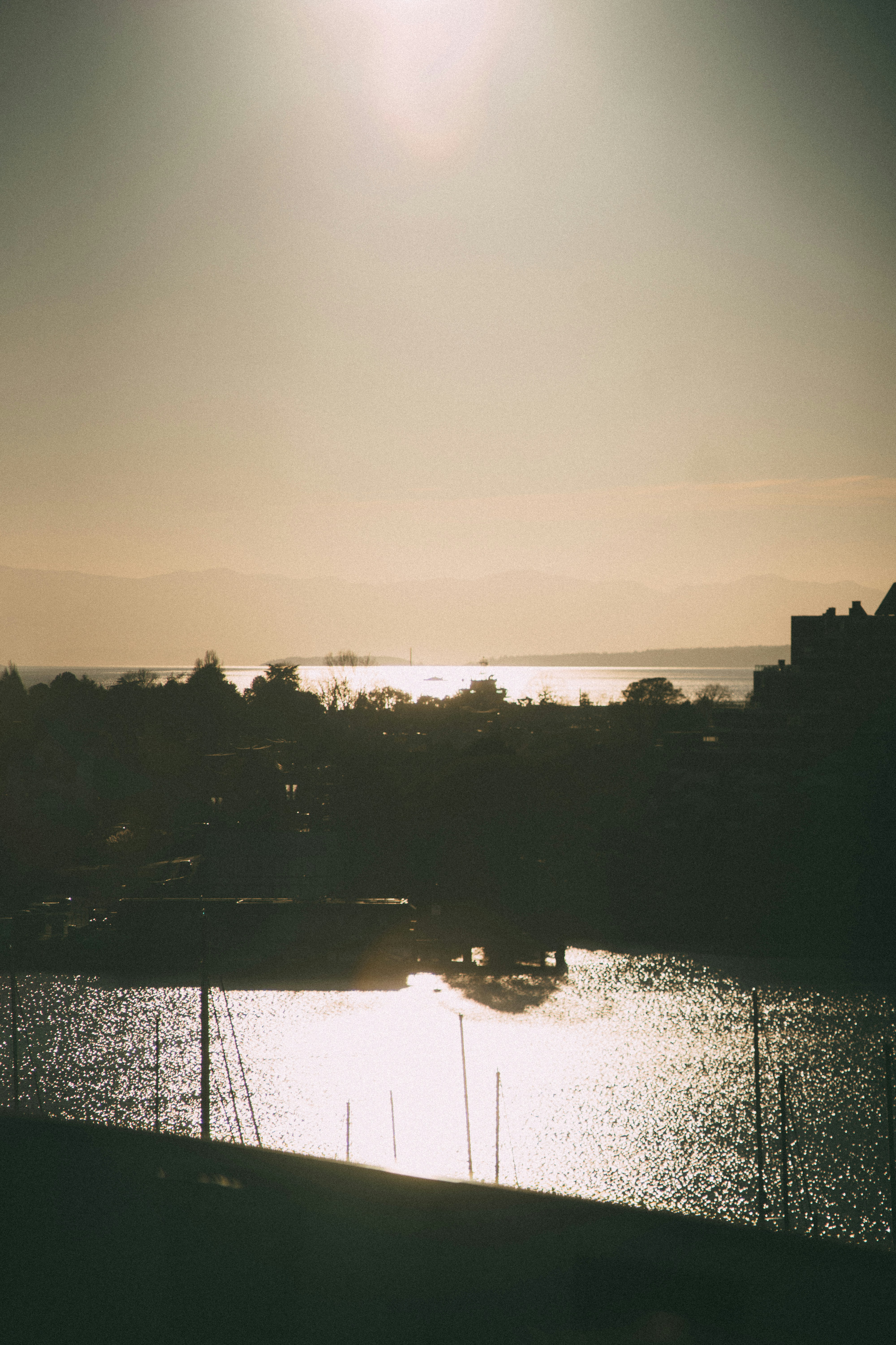 the sun is shining over a body of water