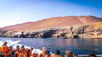a group of people on a boat in the water