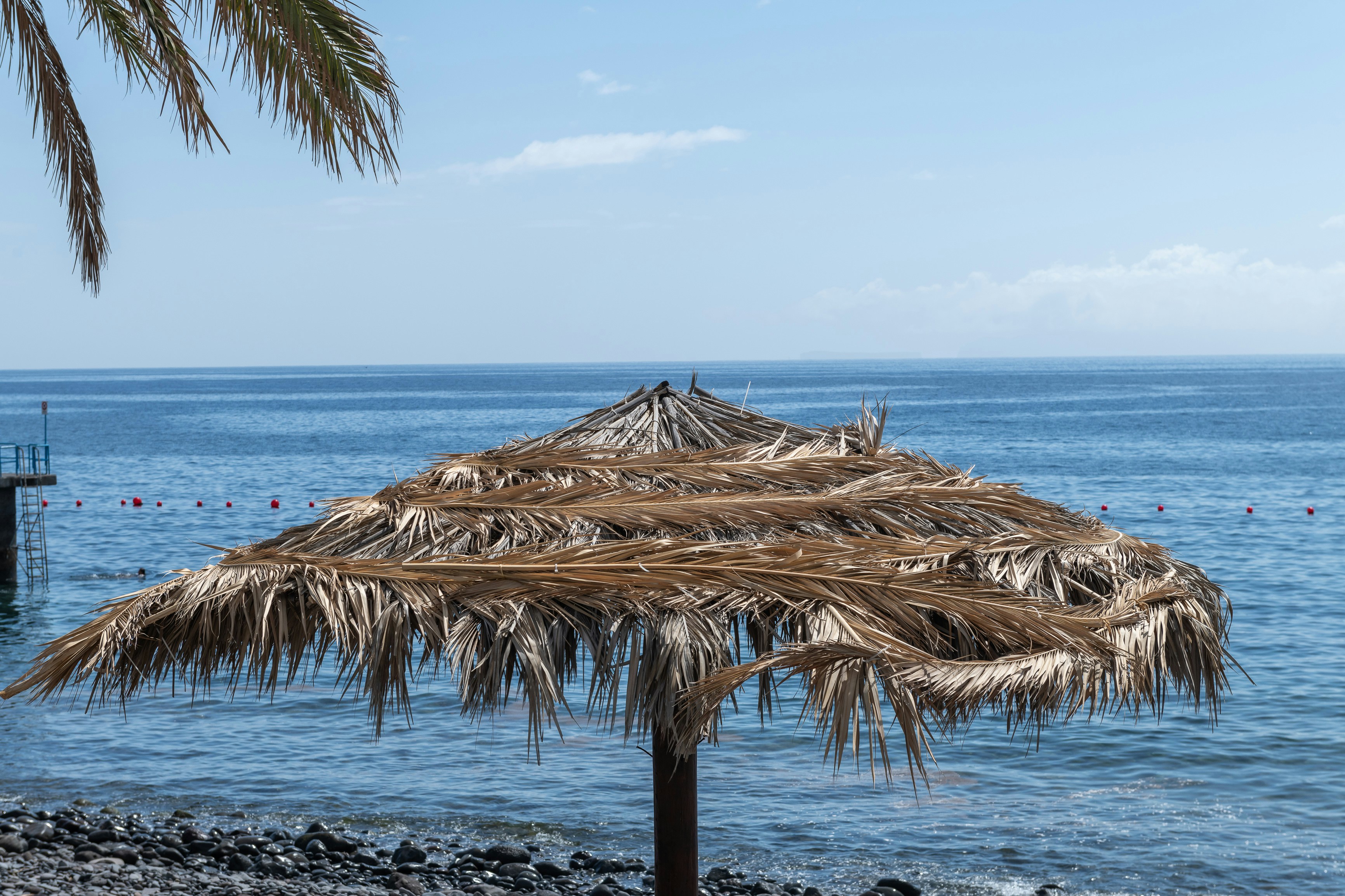 a beach umbrella sitting on top of a sandy beach