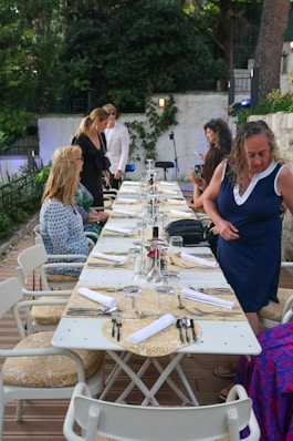 a group of people sitting around a long table