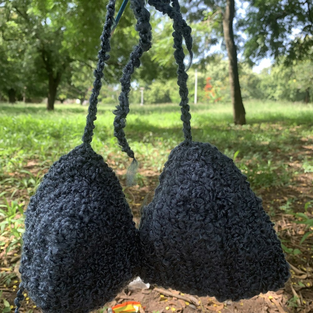 two black crocheted balls hanging from a string