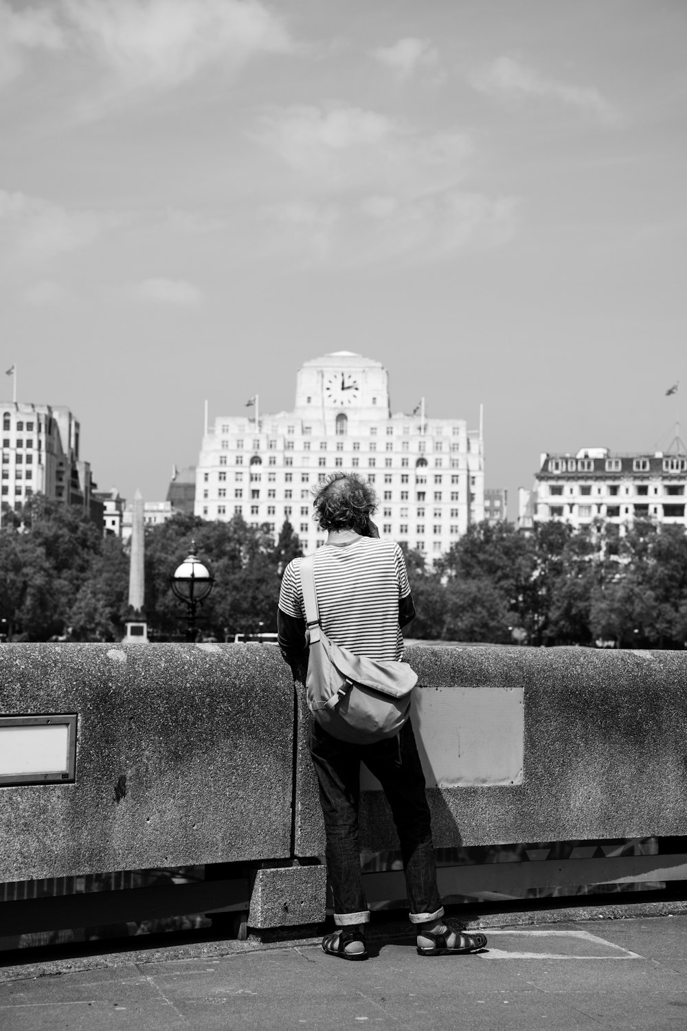 a person sitting on a bench looking at the city