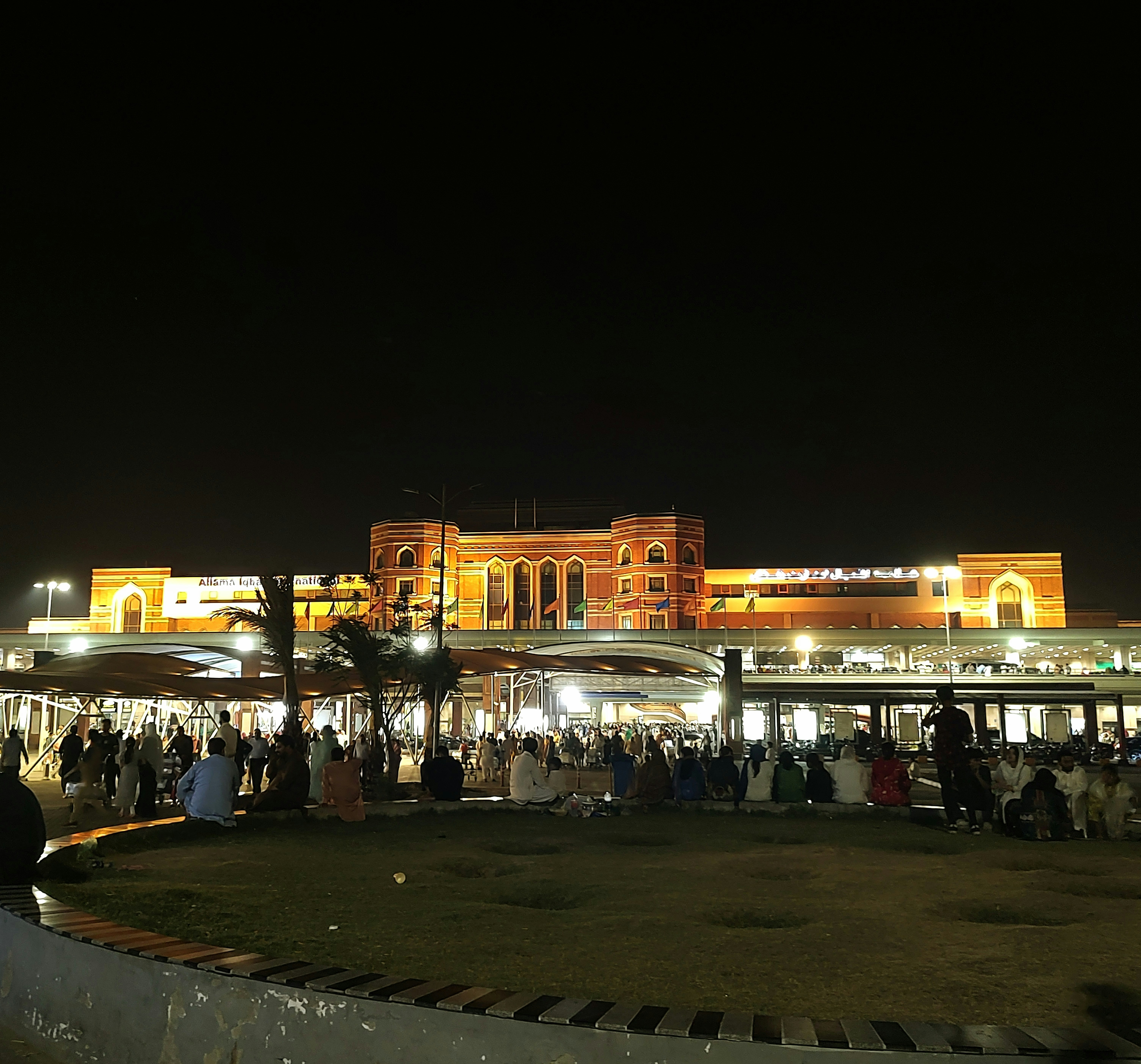 a group of people standing in front of a building at night