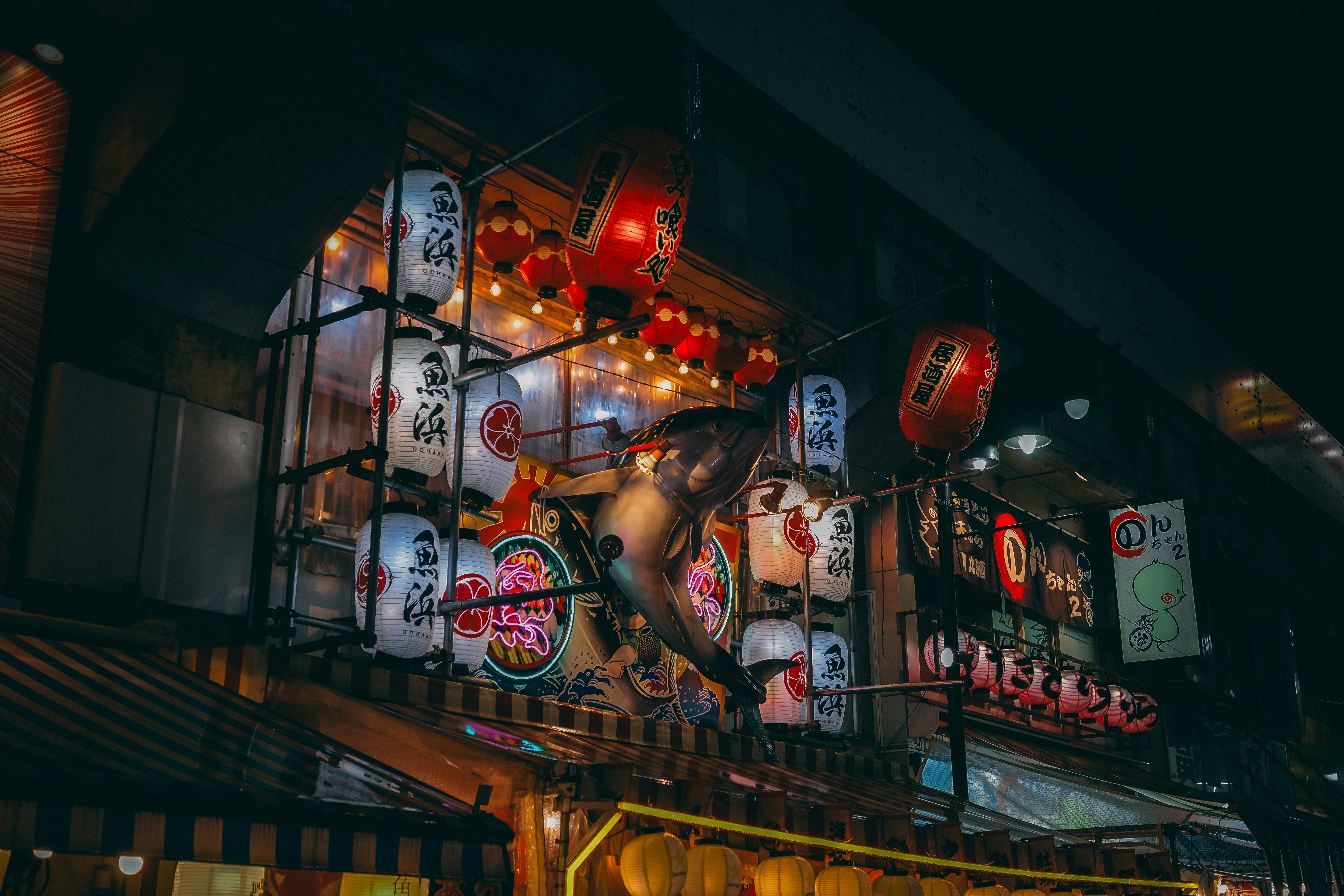 a large display of asian lanterns and signs
