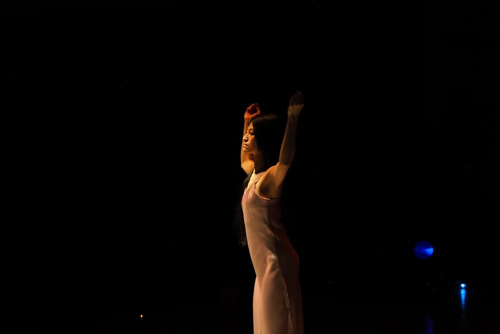 a woman in a white dress standing on a stage